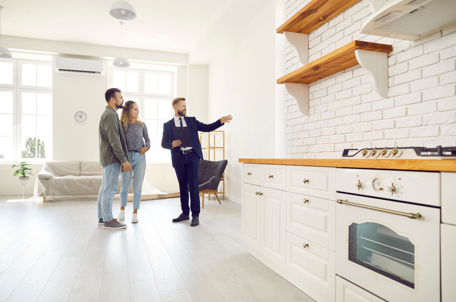 Male relator show home to couple buyers